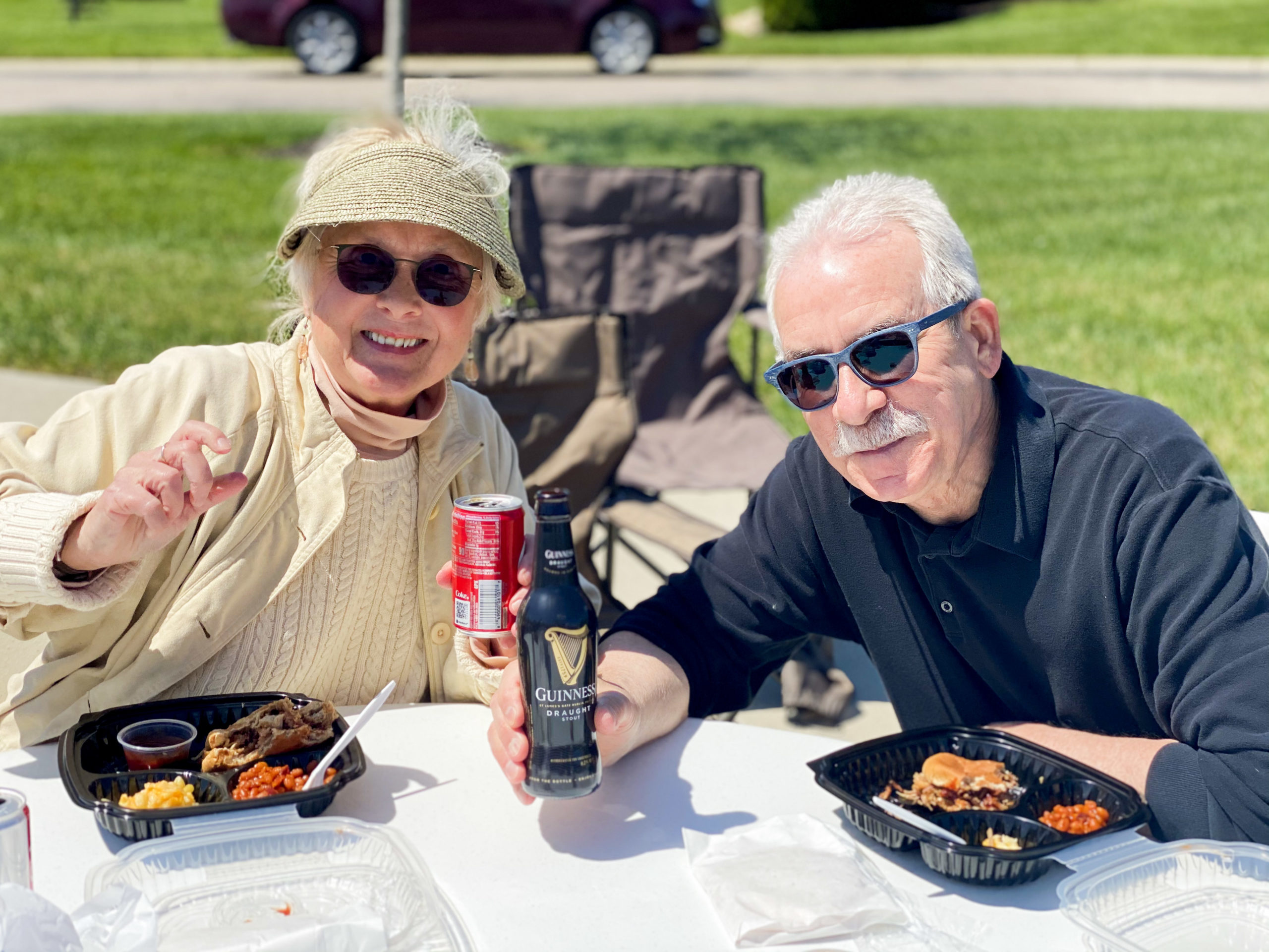 two people eating food outside