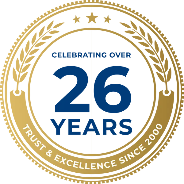 Gold circular anniversary seal: '26 YEARS' with 'Trust & Excellence Since 2000' along the rim.
